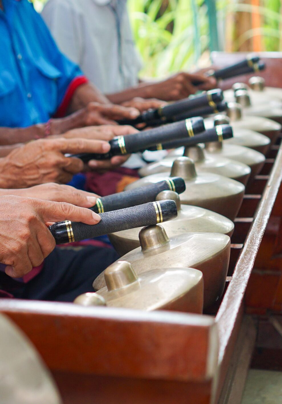 Musicians playing traditional percussion instruments together.